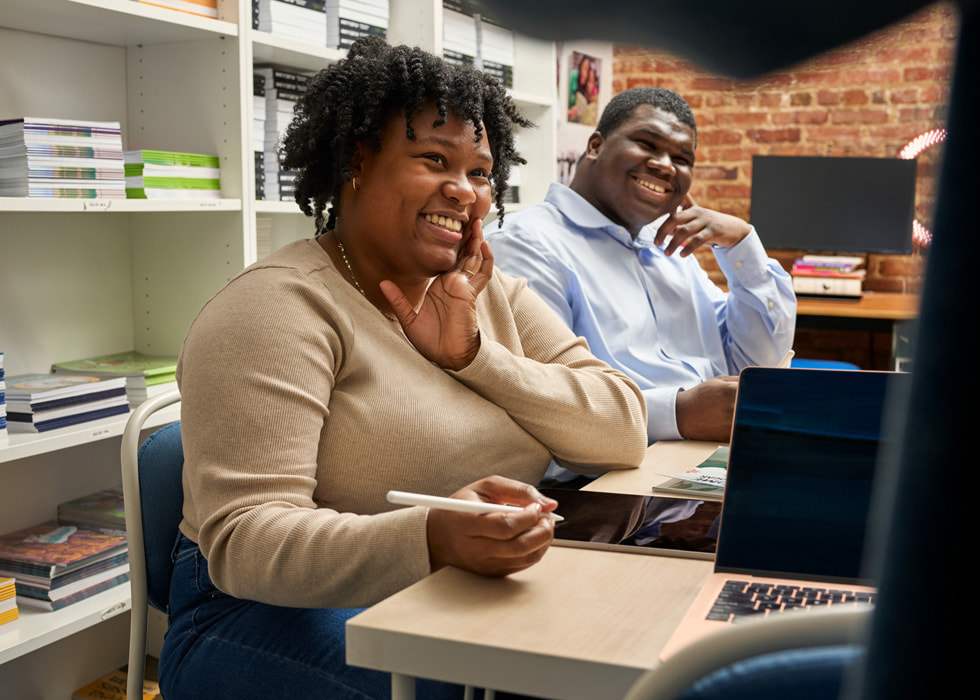 Two Shout Mouse Press participants use Apple Pencil and iPad at the nonprofit’s headquarters.