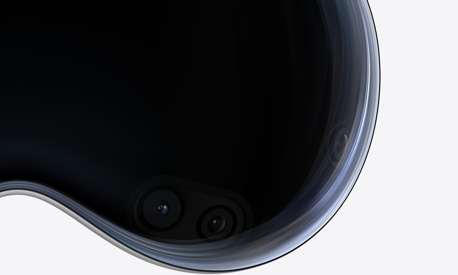 Eine Nahaufnahme der Frontansicht der Apple Vision Pro zeigt Kameras und Sensoren hinter dem gewölbten Glas