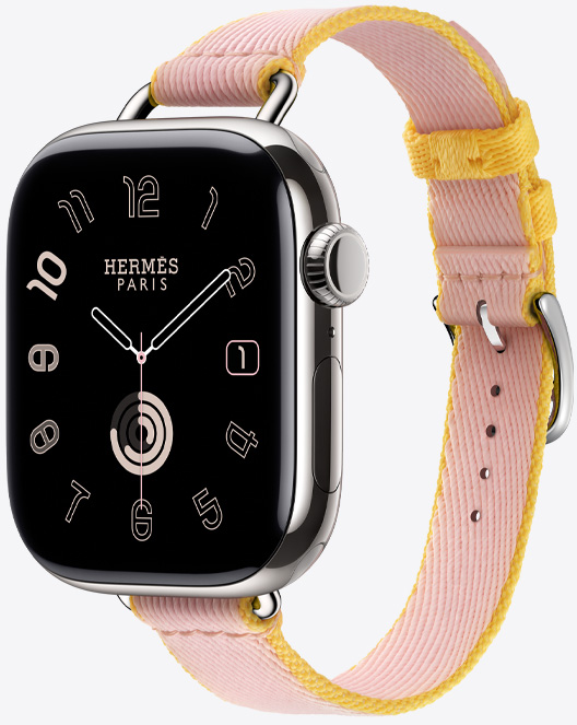 Angled view of the Twill Jump Attelage Single Tour strap in Rose Sakura/Jaune de Naples (pink/yellow) with the Hermès Radial watch face.