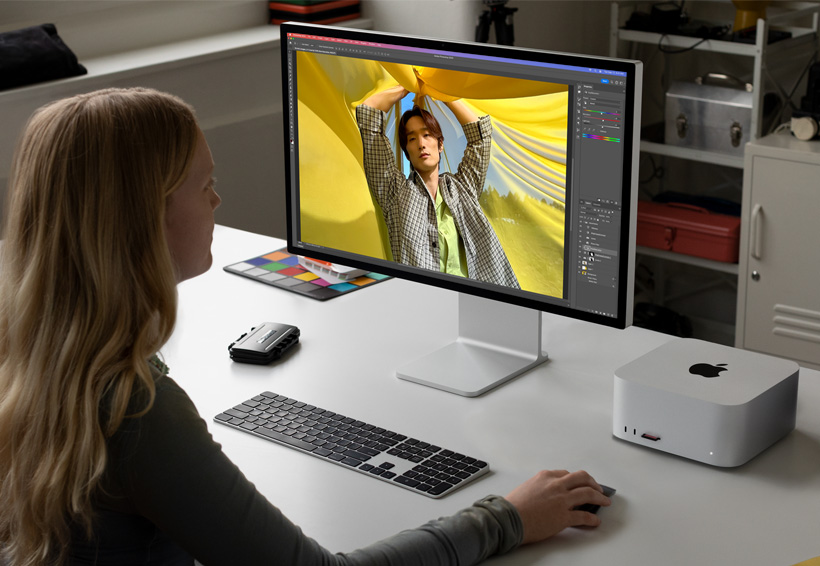 Photographer working with Mac Studio and a Studio Display